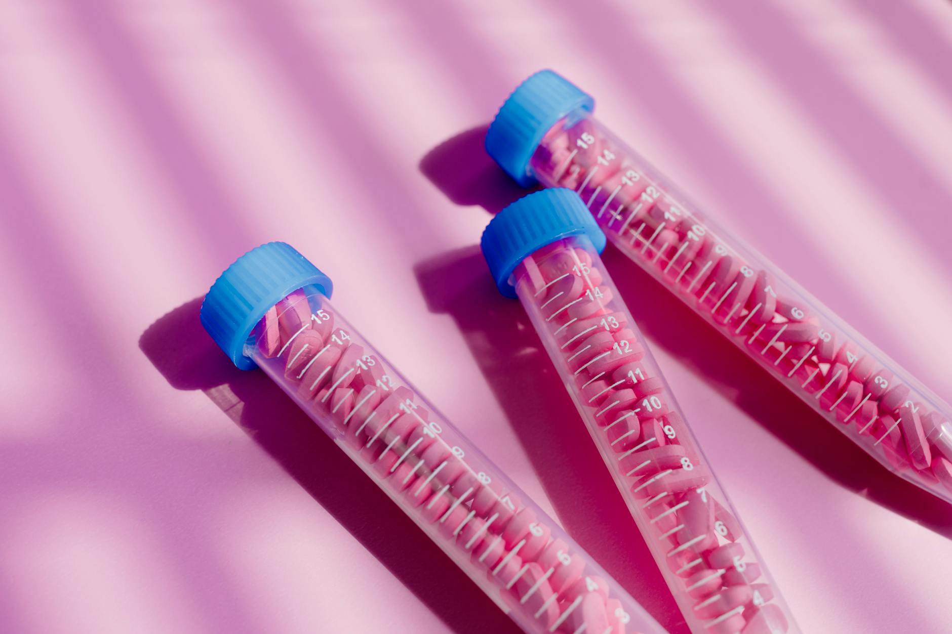 Close-up of several Covid-19 rapid test kits scattered on a wooden table.